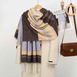 Detail of cashmere-like jacquard scarf with brown purple blocks and white tassels