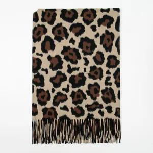 Macro view of leopard print texture and neat tassel edges on a soft winter shawl