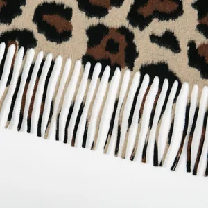 Close-up of leopard print shawl fabric texture with high-quality tassel fringe detail