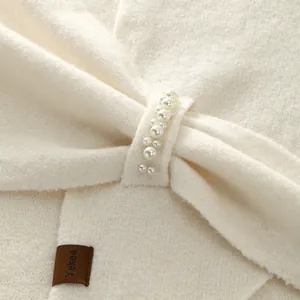 Elegant off-white knitted triangle shawl with pearl embellishments and twist design