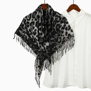 Detailed view of leopard print square scarf with fringes on a white shirt background