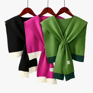 Classic houndstooth knitted shawl in black, pink, and green with ribbed edges