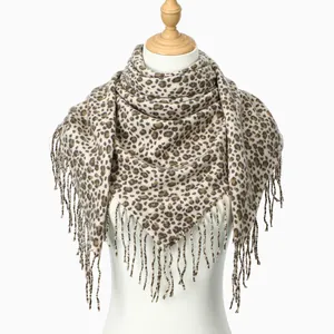 Macro detail of leopard print cashmere feel square scarf with thick fringe edges