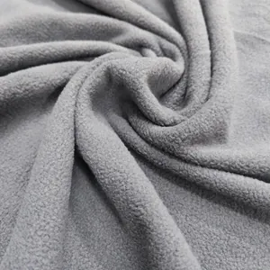 Macro shot of grey fleece fabric texture with soft pile and warm fiber detail