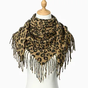 Detail of leopard print scarf with tassels on mannequin showing draped cashmere texture