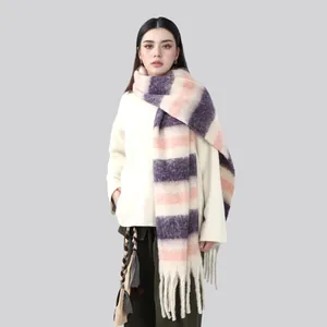 Detail of soft striped knit scarf with long fringes in purple, pink and cream tones