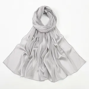 Detail of grey pleated linen scarf texture with elegant vertical stripes and silk sheen