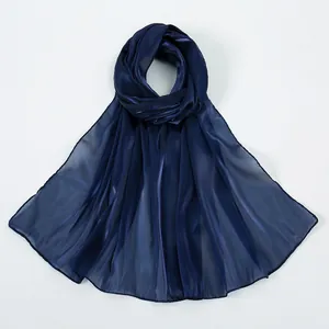 Detail of navy blue lightweight scarf with glossy silk texture and sheer finish