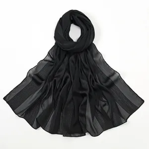 Macro shot of lightweight black floral scarf with subtle silver metallic vertical stripes