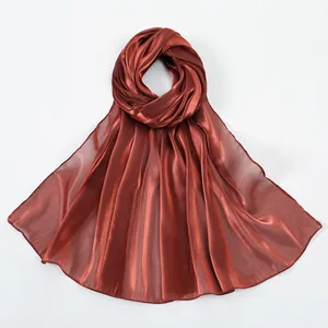 Close-up of lightweight metallic red-brown scarf fabric with smooth satin texture