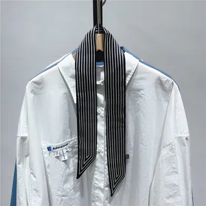 Detail of narrow black and white striped twilly scarf with elegant slanted edges