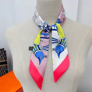 Macro detail of a colorful floral twilly scarf tied on a beige mannequin neck