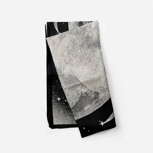 Close-up of minimalist black and white silk scarf with abstract star and meteor patterns