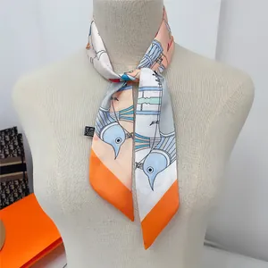 Slim silk-feel scarf with bird and geometric patterns tied on a mannequin neck