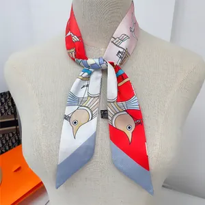 Macro view of silk twilly scarf with sailboat prints tied on a mannequin neck