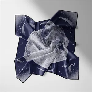 Detail of navy blue silk square scarf with white cosmic moon and star patterns