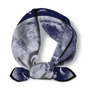 Detail of silk scarf showing astronomical patterns like stars and planets in deep blue