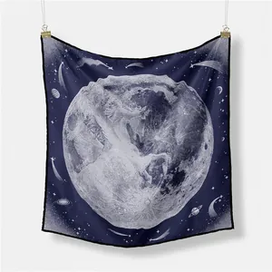 Close-up of square silk scarf featuring white celestial unicorn and moon print on navy blue