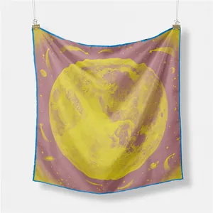 Detail of silk square scarf featuring celestial moon patterns and blue rolled edges