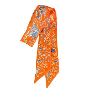 Narrow orange silk scarf with abstract patterns and pointed ends on white background