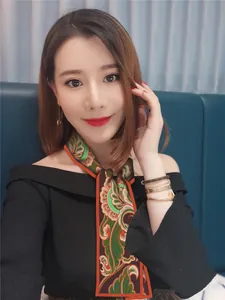 Elegant Dunhuang silk skinny scarf with paisley patterns worn as a stylish neck tie accessory