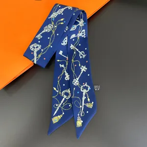 Detail of skinny silk scarf with vintage key patterns and polyester washing label