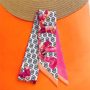Narrow silk twilly with letter print and abstract pattern on orange background