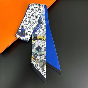 Narrow silk twilly scarf with blue panels and black letter prints on a grey background