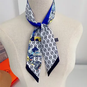 Detail of narrow silk scarf with alphabet print and colorful abstract art patterns