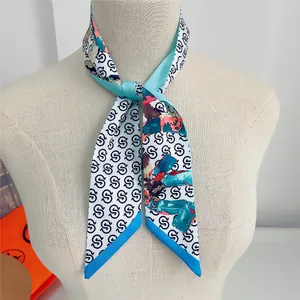 Detail of light blue silk scarf with artistic letter print on a mannequin neck