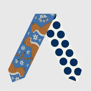 Detail of double-sided silk twilly scarf with leopard print and blue polka dot patterns