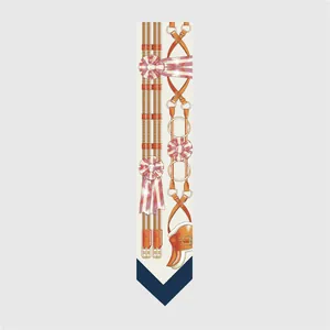 Detailed view of cream-colored twilly silk scarf featuring equestrian bridle and belt prints
