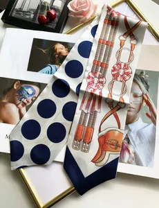 Detailed close-up of double-sided silk twilly scarf with polka dots and equestrian print