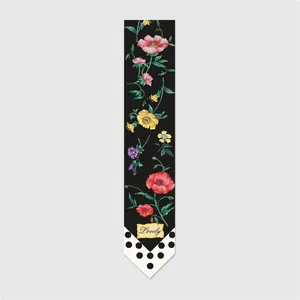 Detailed macro view of a floral silk twilly scarf featuring black polka dots and poppies