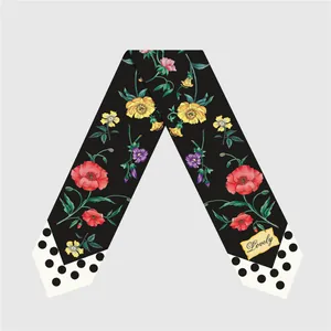 Macro detail of silk twilly featuring floral patterns and polka dot tip with Lovely tag
