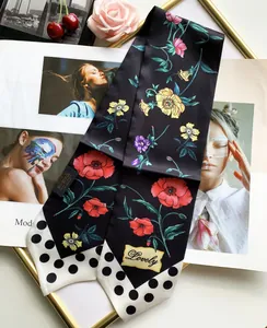 Detailed view of floral silk scarf with black polka dots and Lovely embroidery