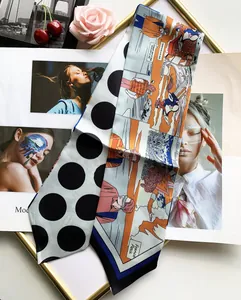 Detail of thin silk twilly scarf with polka dots and colorful comic art illustration