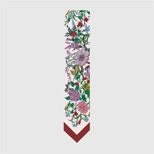 Detail of floral skinny silk scarf showing elegant botanical prints and contrast tip