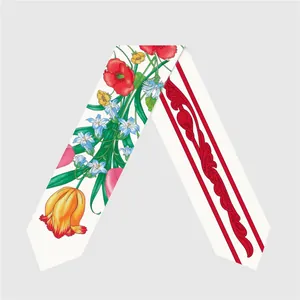 Detailed close-up of a double-sided floral twilly scarf with vibrant blossoms and patterns