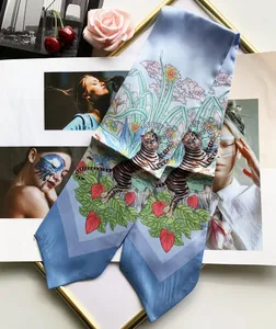 Detail of light blue silk twilly with Lovely Tiger and floral print for neck or hair