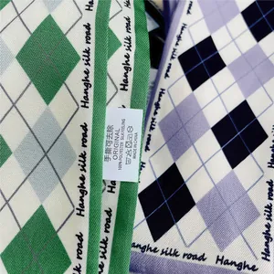 Detailopname van groene en paarse zijden sjaals met een verfijnde twill-weefstructuur en glans