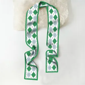 Detail van zijden sjaal met groen argyle-patroon en Hanghe silk road tekst