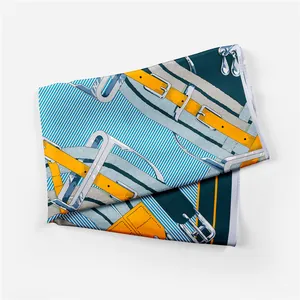 Detailed view of silk scarf with classic equestrian belt patterns and blue stripes