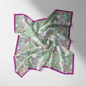 Close-up of tropical floral silk scarf with green leaves and purple border