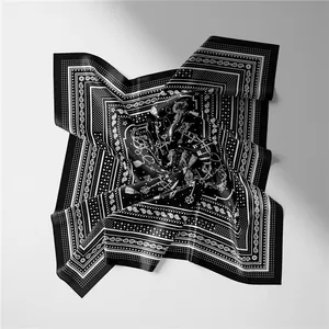 Detailed view of silk square scarf featuring black paisley and vintage key illustrations