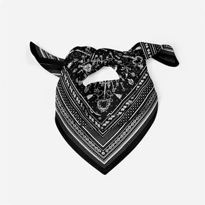 Detailed macro view of black silk scarf with white paisley motifs and vintage key patterns
