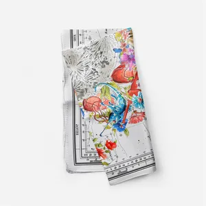 Detail view of premium silk scarf featuring celestial lunar prints and floral patterns