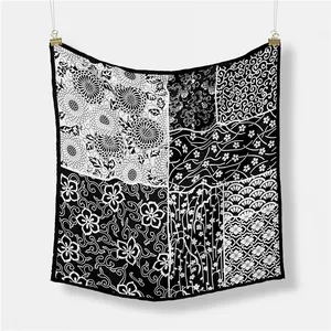 Close-up of lightweight square scarf featuring mixed monochrome floral and wave patterns