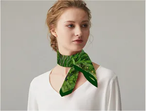 Artistic oil painting style narrow silk scarf in green worn by a model on white shirt