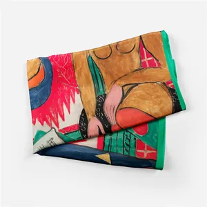 Detailed view of abstract landscape art silk scarf with refined green rolled hem edges